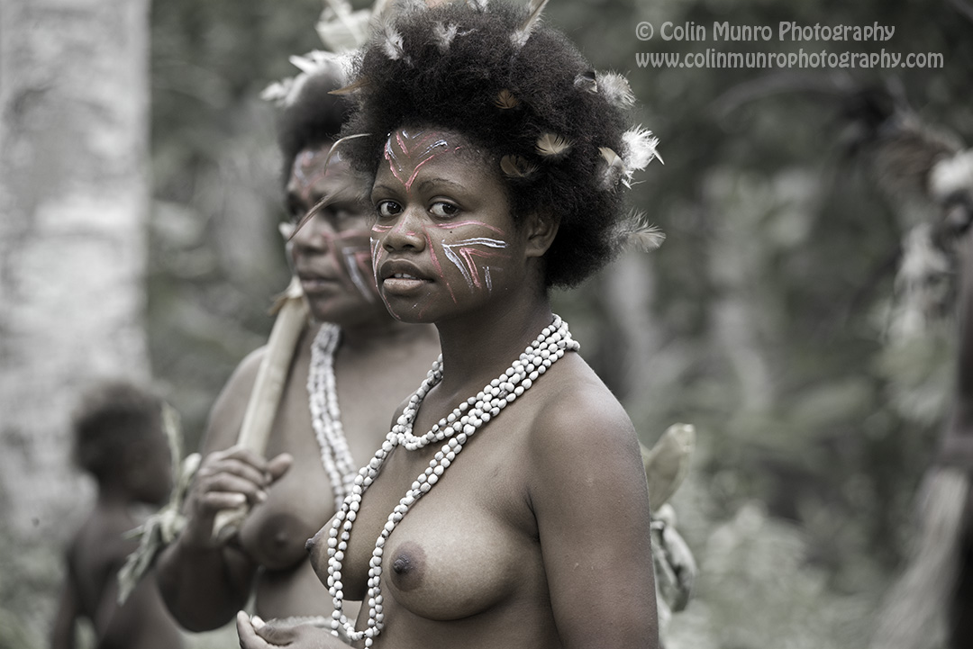 A girl dancer looks shyly at the camera. forest village sing-sing, Malekula island, Vanuatu. Copyright Colin Munro