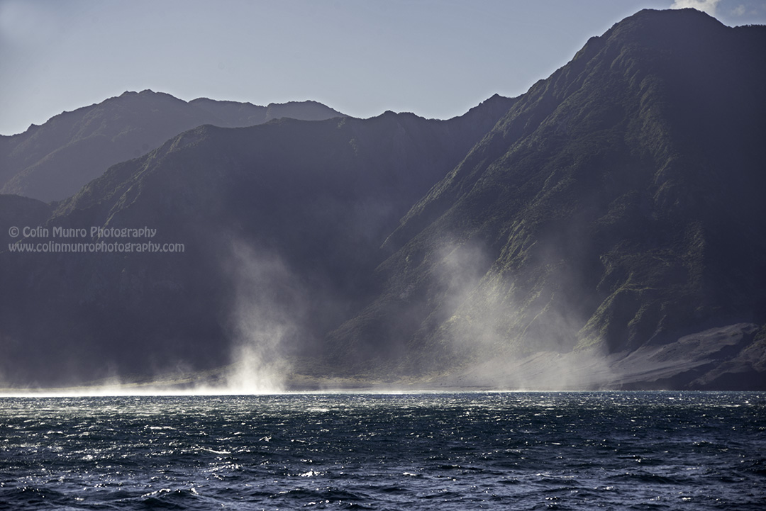 Fierce winds colliding with the steep-sided hills of Cape Palliser force sea spray over 50  metres into the air.