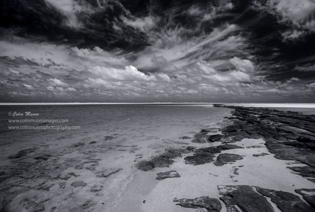 A black and white edit of beach and skyline, One-foot-Island, Aitutaki, Cook Islands, Polynesia. Colin Munro Photography © Colin Munro